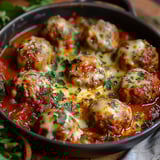 A dish of meatballs in a tomato sauce.