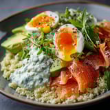 A plate of food with eggs, salad, and fish.